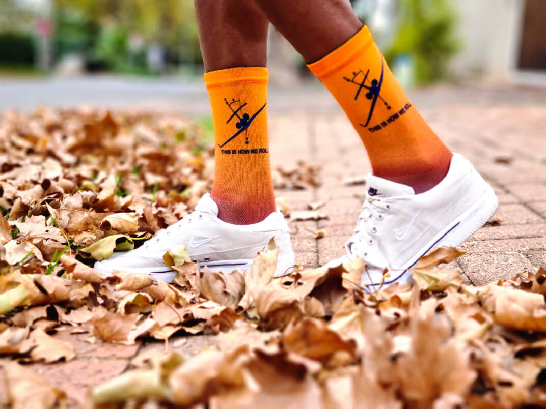 thats how we roll socks on a man with white shoes in the leaves in autumn