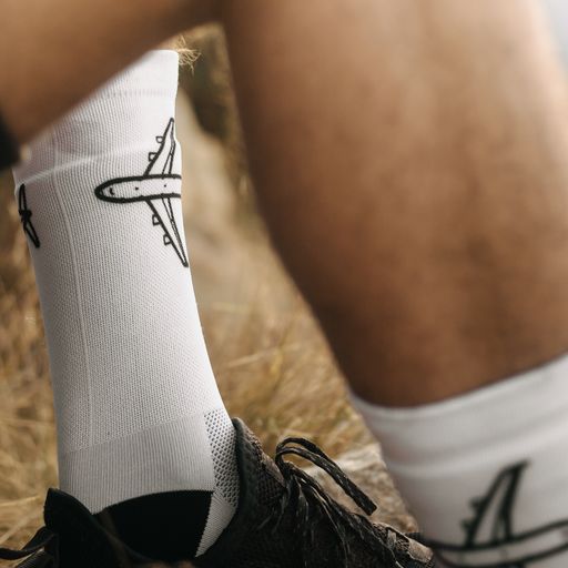 B747 socks on a man sitting in the wilderness