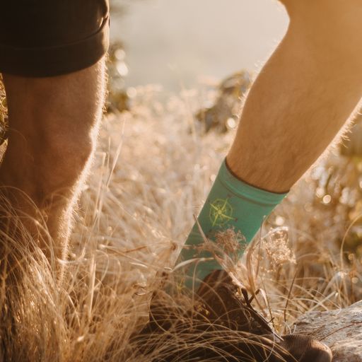Navigator socks on a man hiking in the mountains