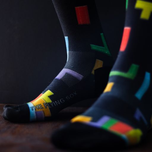 Tetris Socks on a foot model with a black background.
