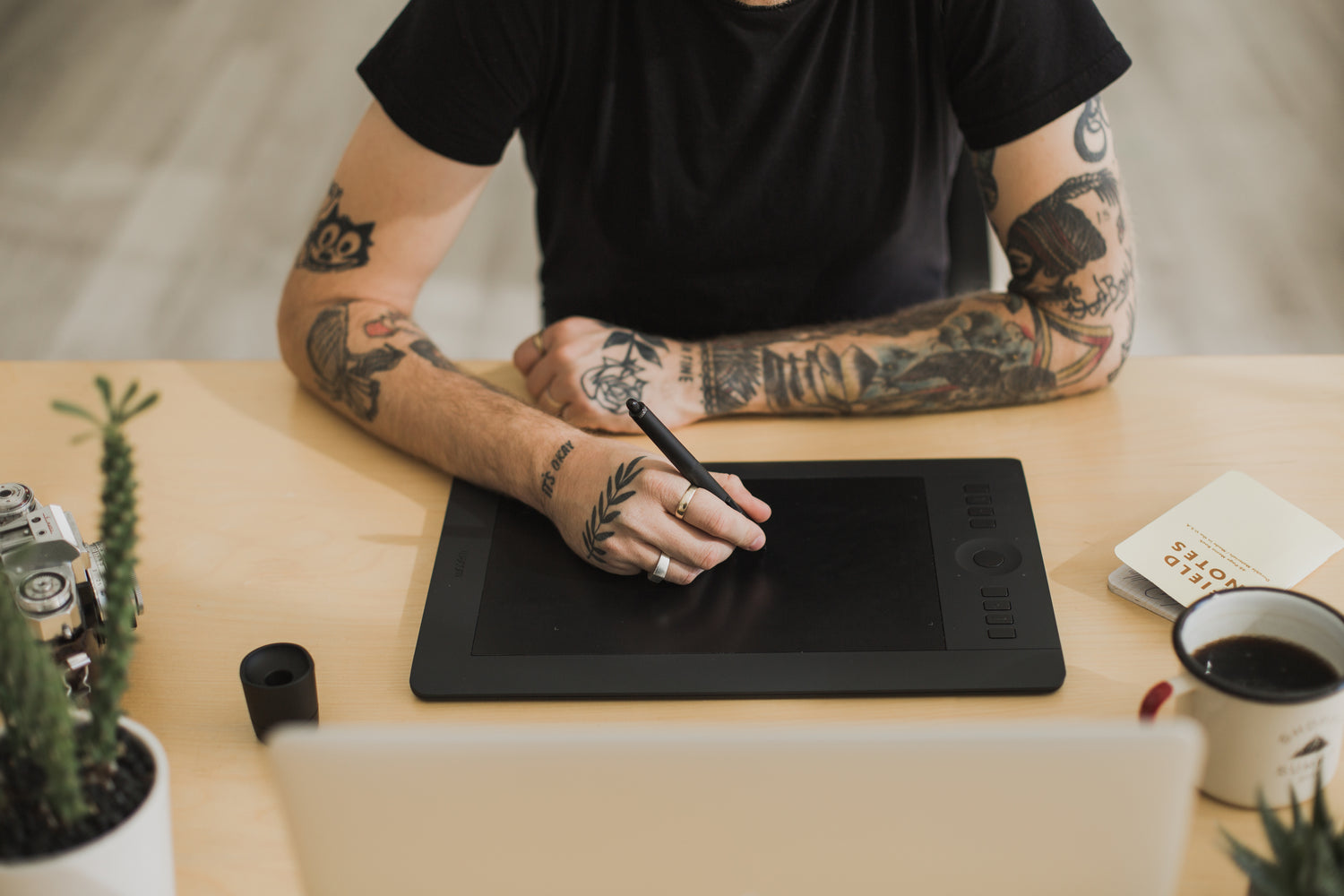 Tattood man designing socks on creative technology